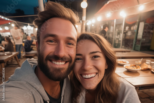 Romantic couple dating night smiling and laughing together having fun. Love and relationship young people enjoying nightlife. Tourist on vacation. Outdoor leisure activity. Taking selfie