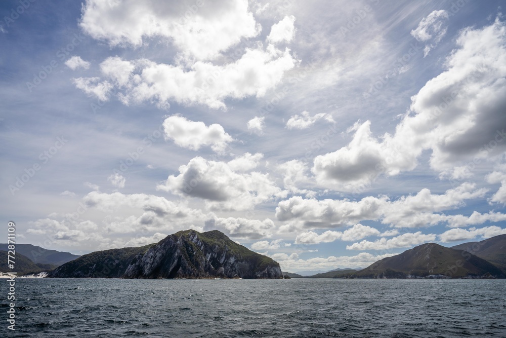sailor sailing a yacht with a sail on a beautiful day exploring the australian coastline of tasmania sailor sailing a yacht with a sail on a beautiful day exploring the australian coastline of tasmania