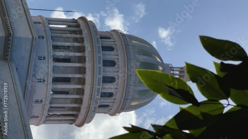 The famous building of the National Capitol in Cuba. HAVANA - DECEMBER 20, 2023: The entrance staircase and the dome of the Capitol in the center of Havana against the background of a blue sunny sky. photo