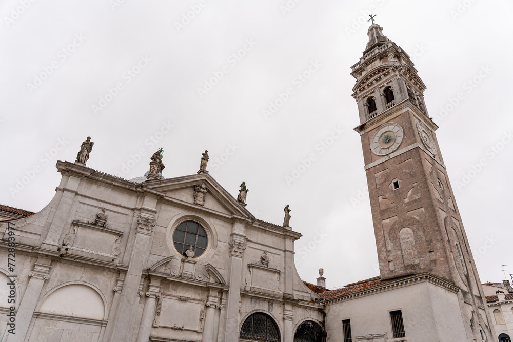 Fototapeta premium Venice church in a square with a large clock tower