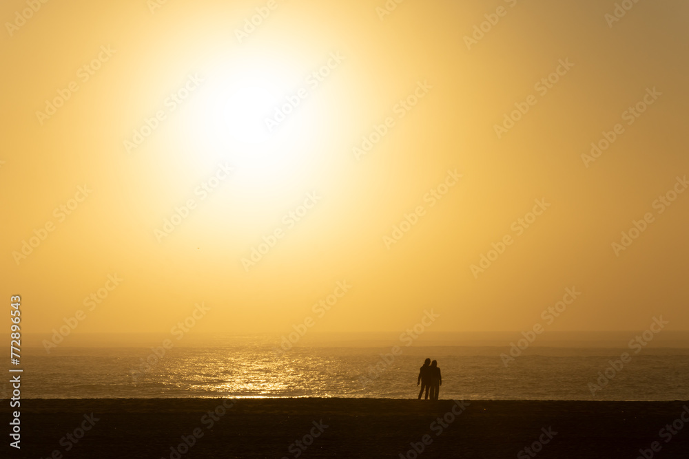 couple on the beach at sunset couple on the beach at sunset