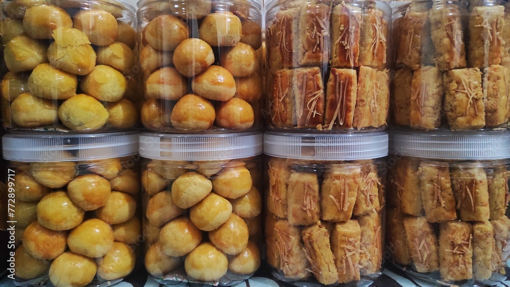 A pile of jar filled with cheese cookies called 'Kastengel' and cookies stuffed with pineapple jam called 'Nastar' were ready to sale