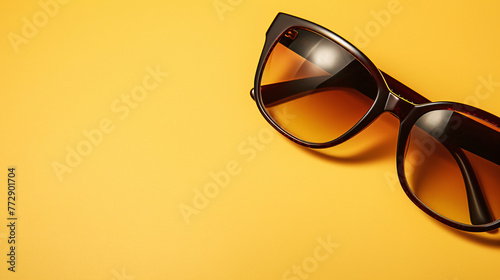 a pair of sunglasses on a yellow background