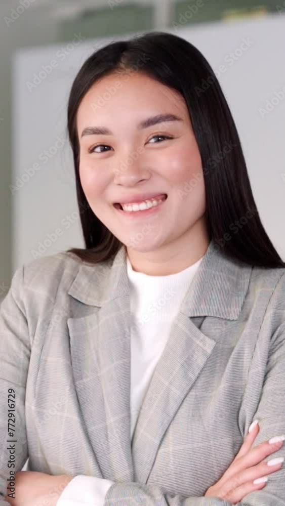 Vertical closeup portrait of eastern young asian woman happily smiling looking at camera in home office interior. Headshot of Korean beautiful millennial businesswoman entrepreneur, remote freelancer Vertical closeup portrait of eastern young asian woman happily smiling looking at camera in home office interior. Headshot of Korean beautiful millennial businesswoman entrepreneur, remote freelancer