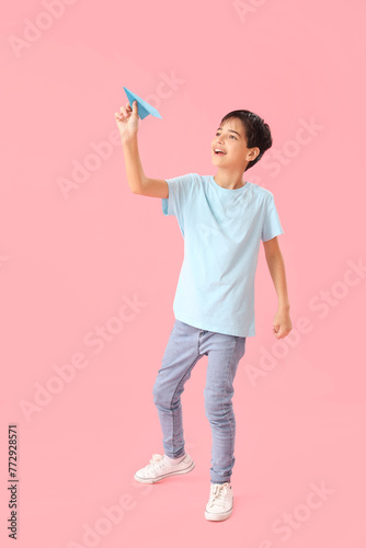 Little boy with paper plane...