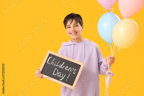 Little boy holding chalkboa...
