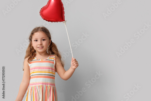 Little girl with heart shap...