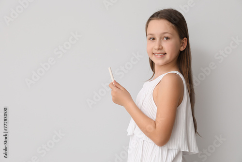 Little girl with chalk piec...