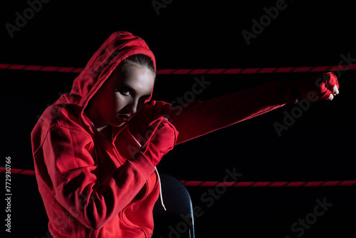 The athlete hits the fist straight ahead. Technical training before the fight in the ring.