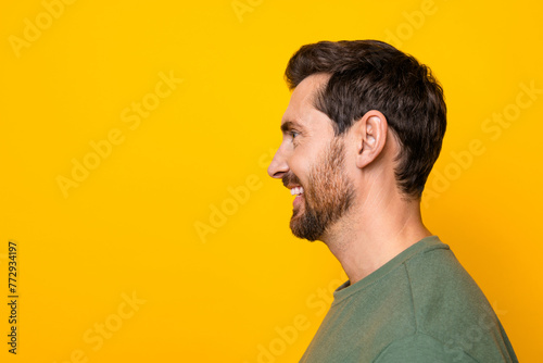 Photo portrait of handsome young guy profile look empty space smiling dressed stylish khaki outfit isolated on yellow color background