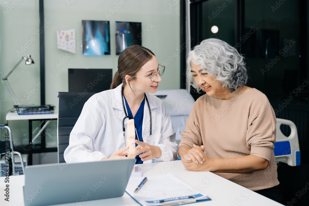 Portrait of female doctor explaining diagnosis to her patient. Doctor Meeting With Patient In Exam Room. A medical practitioner reassuring a patient Portrait of female doctor explaining diagnosis to her patient. Doctor Meeting With Patient In Exam Room. A medical practitioner reassuring a patient
