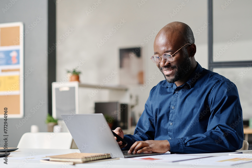 Black Man Working On Computer In Modern Office Black Man Working On Computer In Modern Office