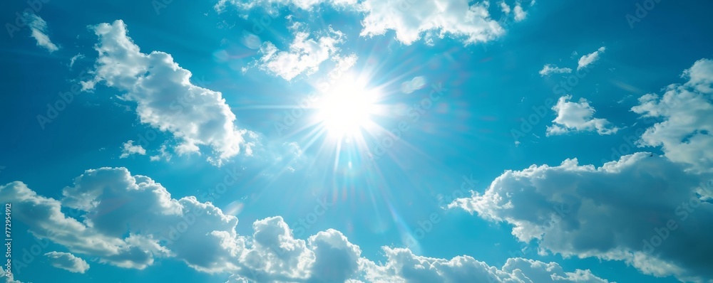 Bright sun shining in blue sky with fluffy clouds Bright sun shining in blue sky with fluffy clouds