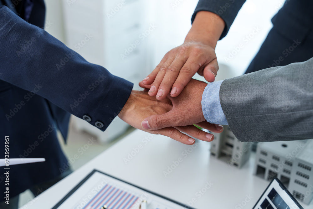 Two business executives, elegantly attired in suits, join hands in a gesture of unity, solidarity, and shared commitment towards a common goal or venture. Two business executives, elegantly attired in suits, join hands in a gesture of unity, solidarity, and shared commitment towards a common goal or venture.