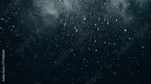 snowflakes falling against black backdrop photo