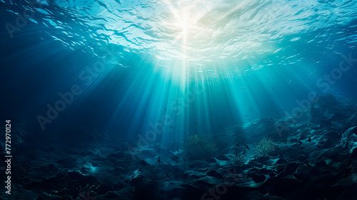 Sunlight shining through the water s surface in a deep blue ocean