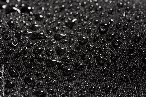 Close-up view on water drops on waterproof impregnated fabric in rain photo