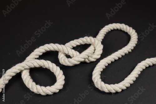 Rope with a knot on dark background