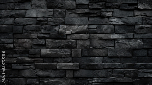 Black stone wall close up with fire hydrant photo