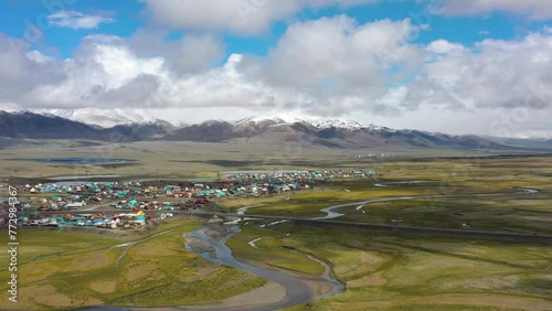 Kosh agach town from above surrounded by steppes, mountains and rivers, Altay Republic, Russia, Siberia. Small settlement, beautiful clouds landscape, aerial drone view photo