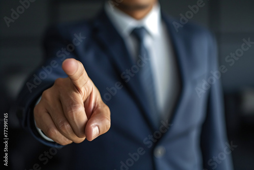 a hand in a suit pointing at something