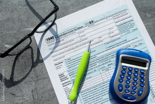 1040 Individual income tax return form blank with pen glasses calculator photo