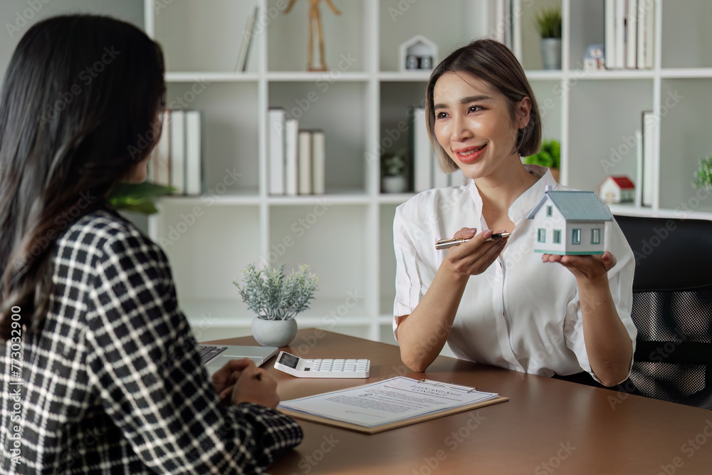 Real estate agent talked about the terms of the home purchase agreement and asked the customer to sign the documents Real estate agent talked about the terms of the home purchase agreement and asked the customer to sign the documents