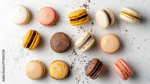 colourful french macrons lined up on the white background close up, crumbs around pink red brown beige blue cakes, delicious dessert, flat lay with copy space, top view photo