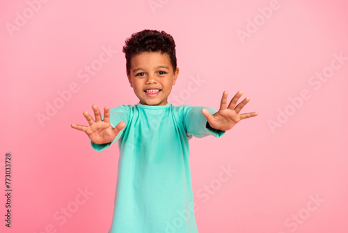 Photo portrait of charming small boy stretch hands want hugging wear trendy aquamarine outfit isolated on pink color background