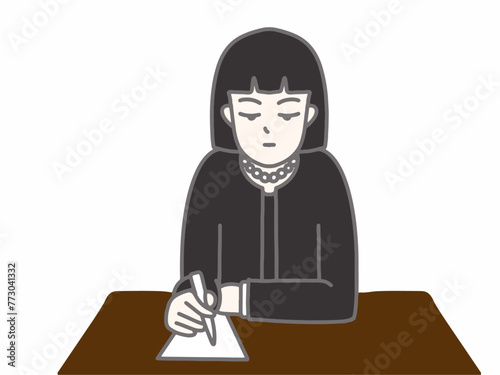 黒いスーツを着て字を書いている女性
