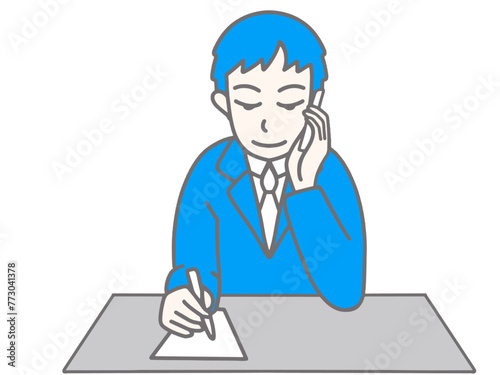 携帯電話で話しながらメモをしている男性