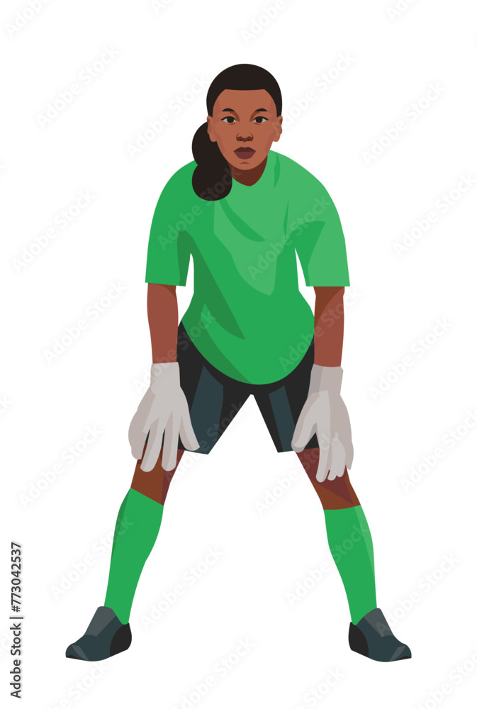 Angolan teenage girl goalkeeper of junior women's football teem in green uniform and gloves who stands upright in goal and waits for the ball
