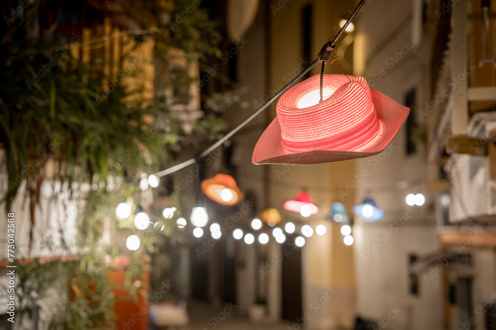 Hanging red hat-lantern on the street of the old town of Bari. Italy - obrazy, fototapety, plakaty 