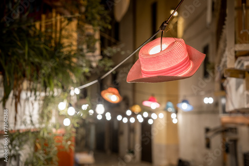 Hanging red hat-lantern on the street of the old town of Bari. Italy