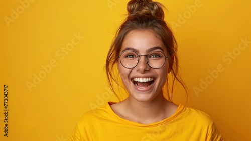 A woman with glasses wearing a yellow shirt