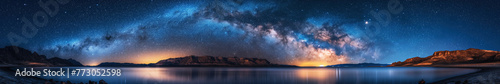 panorama landscape with milky way in a blue night starry sky against background of lake water and mountains