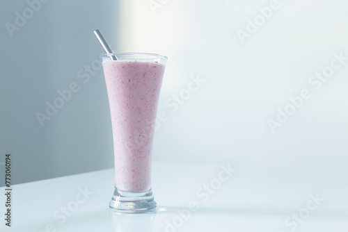 Wallpaper Mural Tall glass with strawberry smoothie and stainless steel straw set in natural light on white background Torontodigital.ca