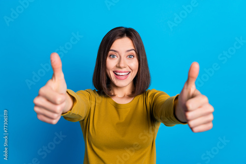 Photo of adorable confident lady dressed shirt showing two thumbs up isolated blue color background © deagreez