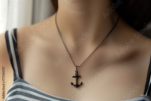 a person wearing an anchorshaped necklace photo