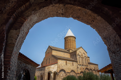 Saint George church glimpsed through an archway in the medieval architecture of Alaverdi Monastery Complex,, Kakheti, Georgia