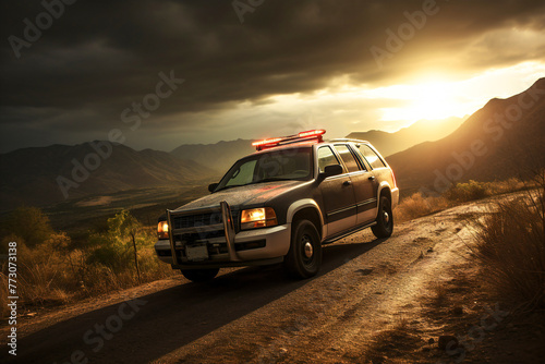 A border patrol vehicle stands by the border fence, ensuring border security.