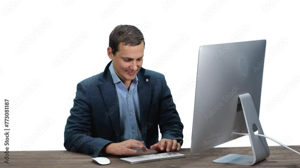 Young adult man employee sitting in front of computer typing and talking, Full HD footage with alpha transparency channel isolated on white background Young adult man employee sitting in front of computer typing and talking, Full HD footage with alpha transparency channel isolated on white background