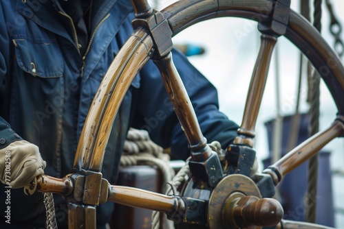 crew member steering wooden ship wheel