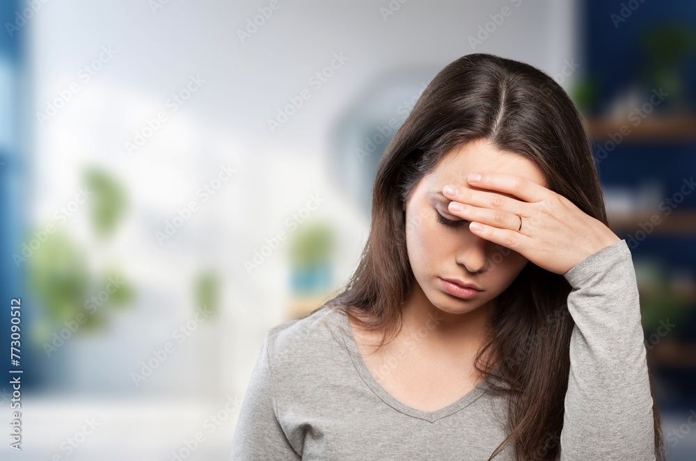 Sad and worried woman crying at home Sad and worried woman crying at home