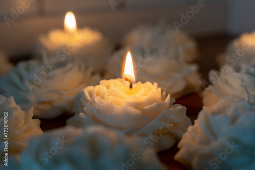 Lit rose shaped white soy wax candles