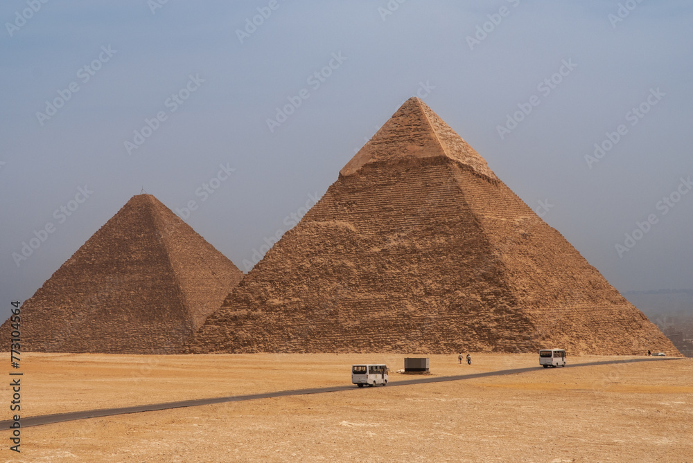 Giza Pyramid Complex is complex of ancient monuments on Giza Plateau. Pyramids of Khafre (Khafre) and Mikerin (Menkaure) against blue sky background. Cairo, Egypt - April 18, 2008 Giza Pyramid Complex is complex of ancient monuments on Giza Plateau. Pyramids of Khafre (Khafre) and Mikerin (Menkaure) against blue sky background. Cairo, Egypt - April 18, 2008