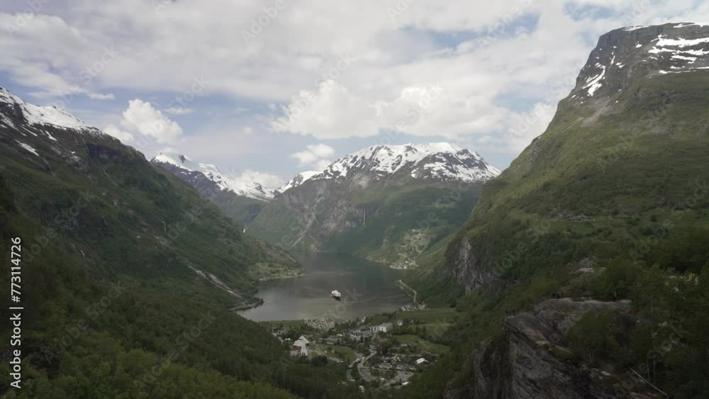 Beautiful Geiranger Fjord is a well known and popular travel destination for cruise ships and offers spectacular views to the norwegian landscape with deep gorges and snow covered mountain ranges.
