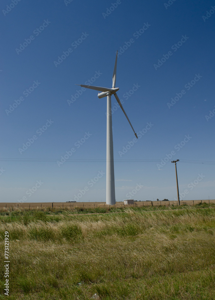 windmills with wind energy turbines in the countryside to generate clean energy