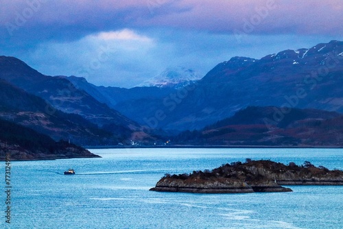 Tranquil lake nestled between majestic mountain ranges at sunset in Kyle of Lochalsh, Scotland, UK photo