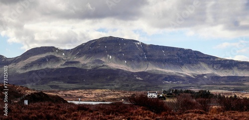 a hill in the distance with a building in front of it